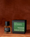 Three Ranger Station x Tecovas fragrance products labeled "Waterloo" are arranged in front of a green and black product box on a brown surface with a brown background.